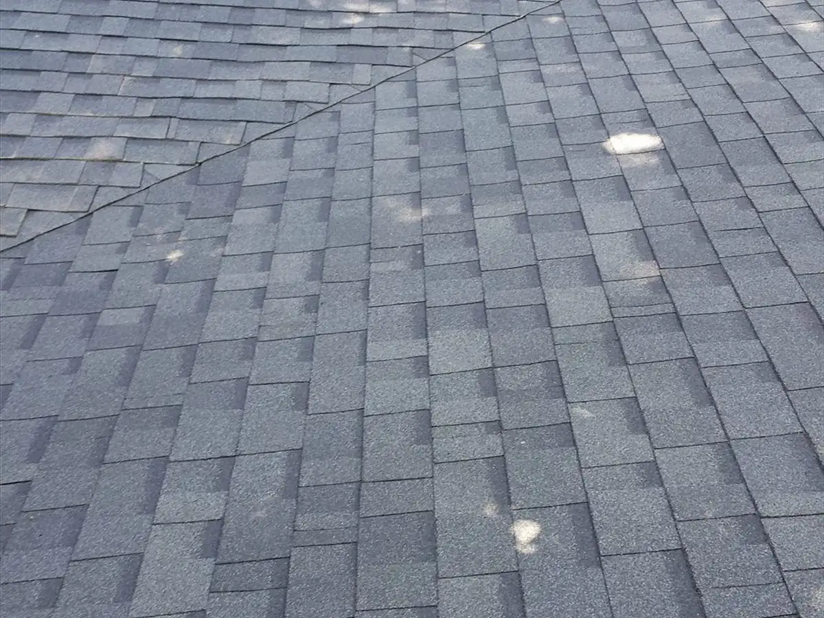 Two roof planes meeting in a cleanly cut shingle valley