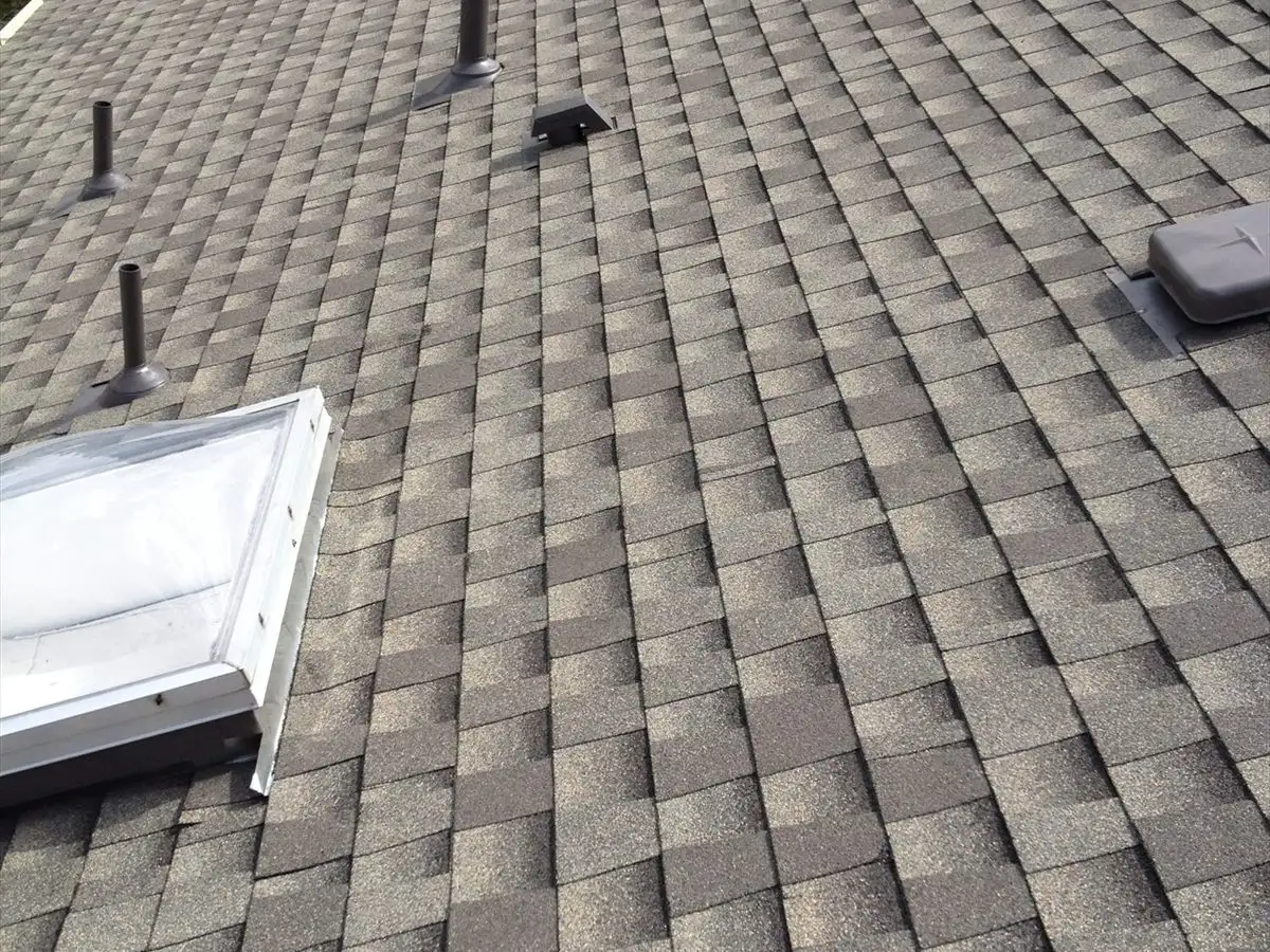 New shingle roof with skylights and plumbing vents flashed in