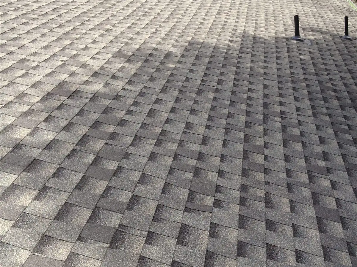 Wide view of a completed shingle roof with skylights